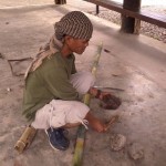 One of the guides giving demonstration on starting a fire using bamboo only